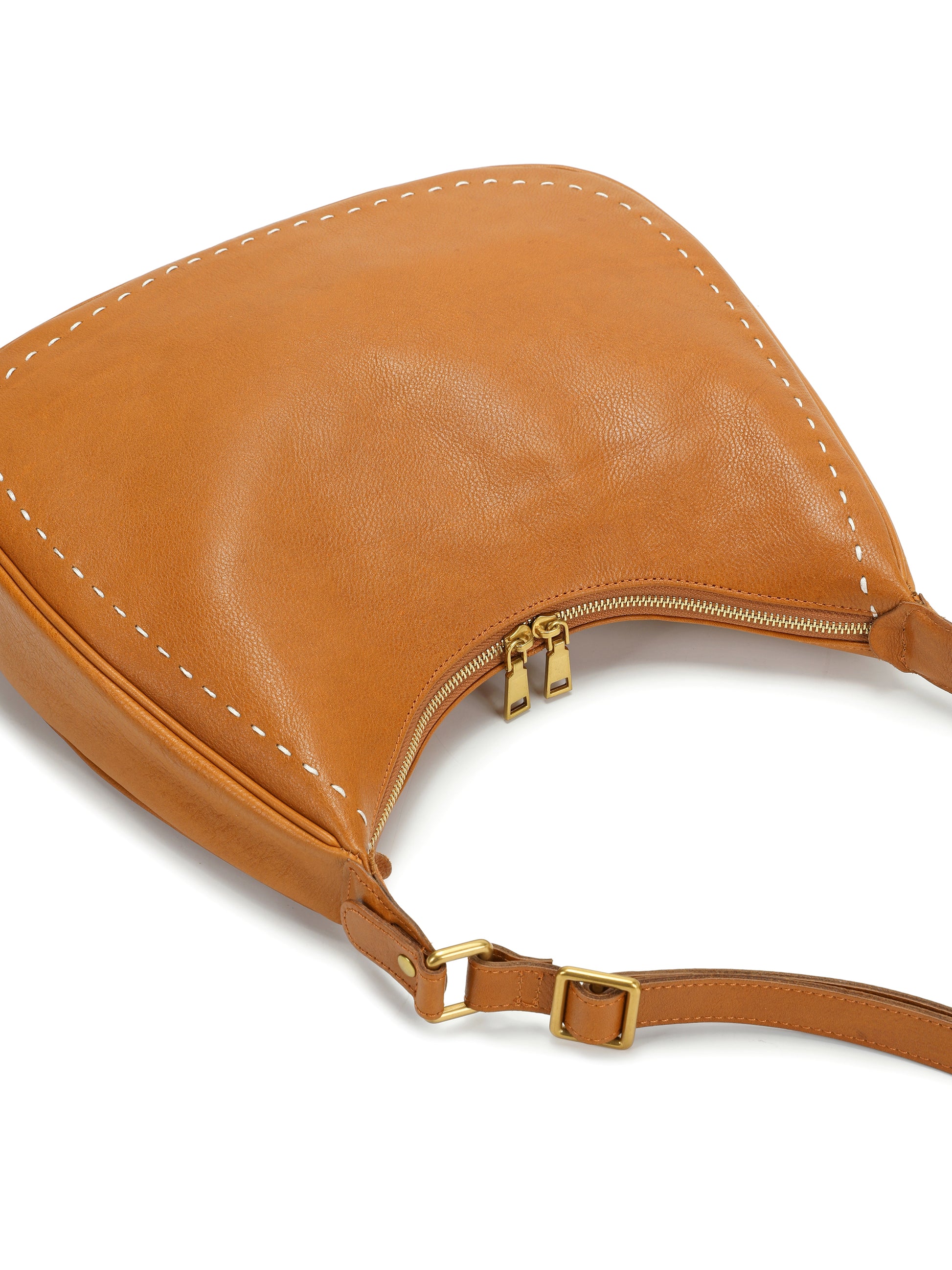 Tan leather shoulder handbag with gold zipper and white stitch detailing on white background