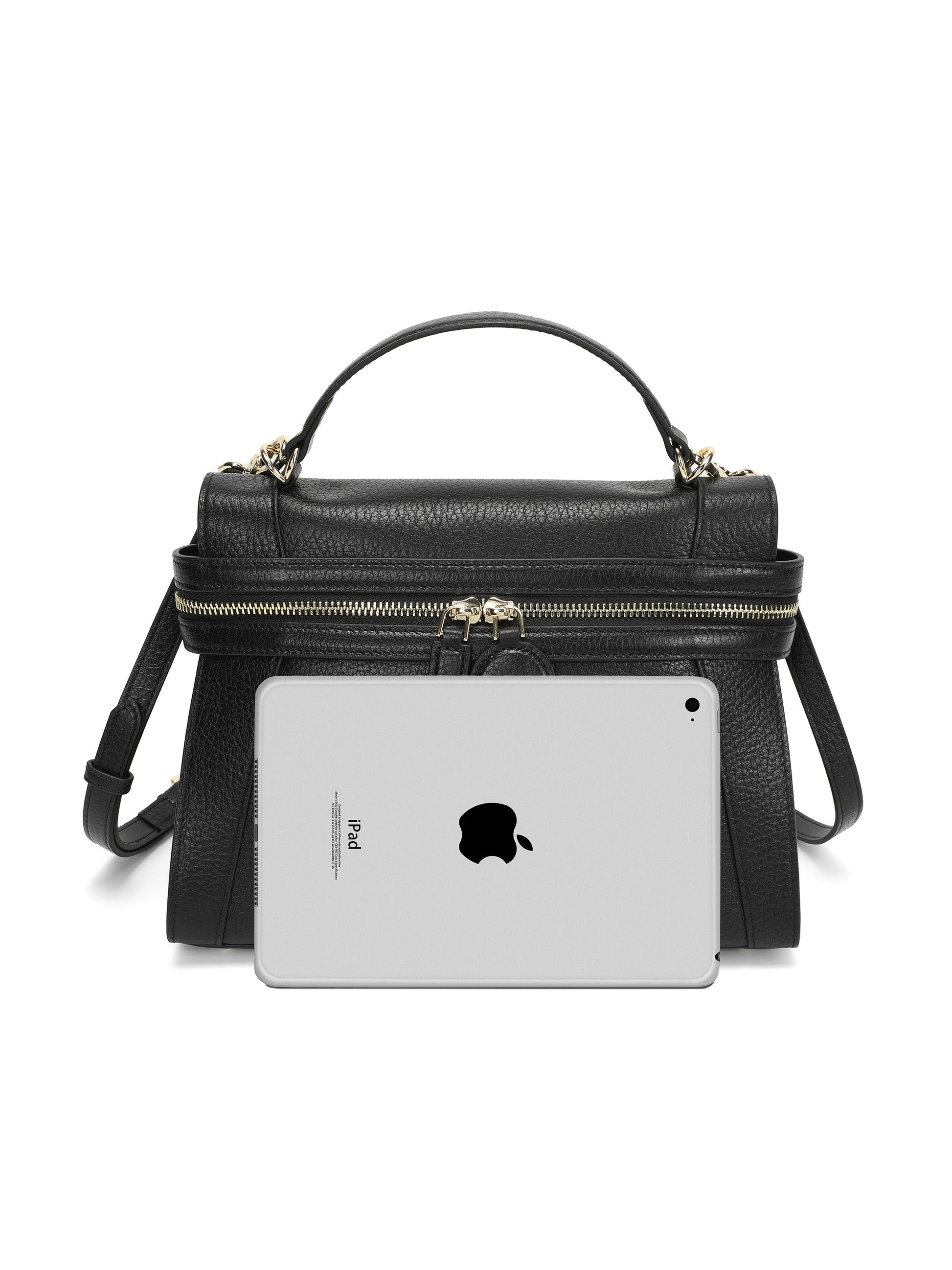 Black leather handbag with gold zippers and top handle, size comparison with iPad in front