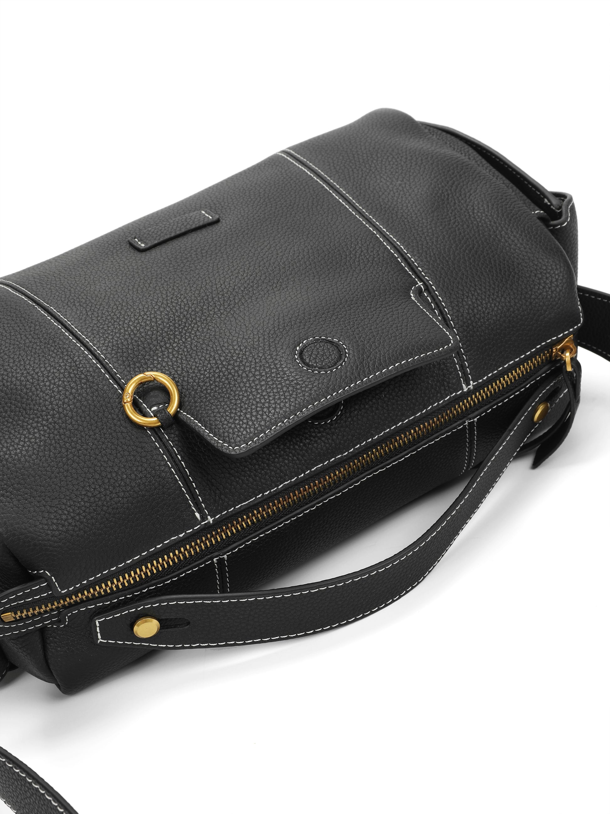 Black leather handbag with gold hardware, white stitching, and zip closure on white background.