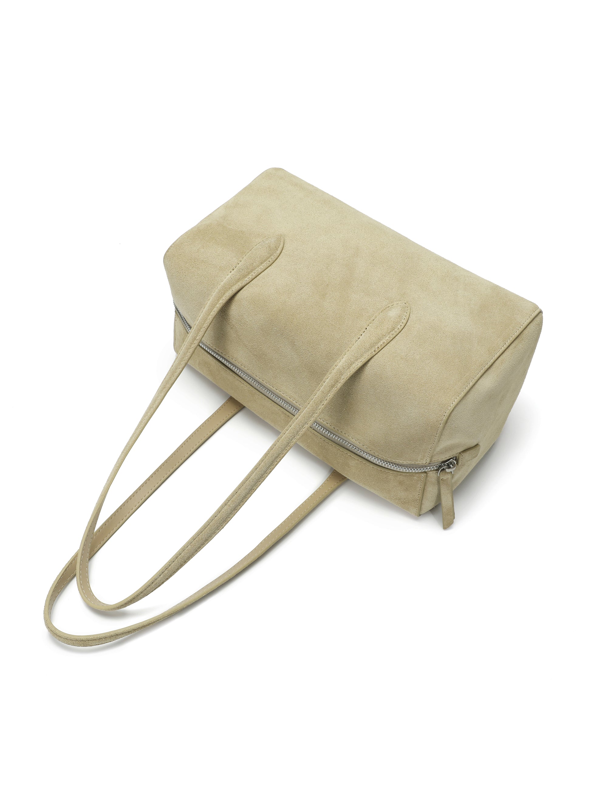 Beige suede shoulder handbag with long straps and zip closure on white background