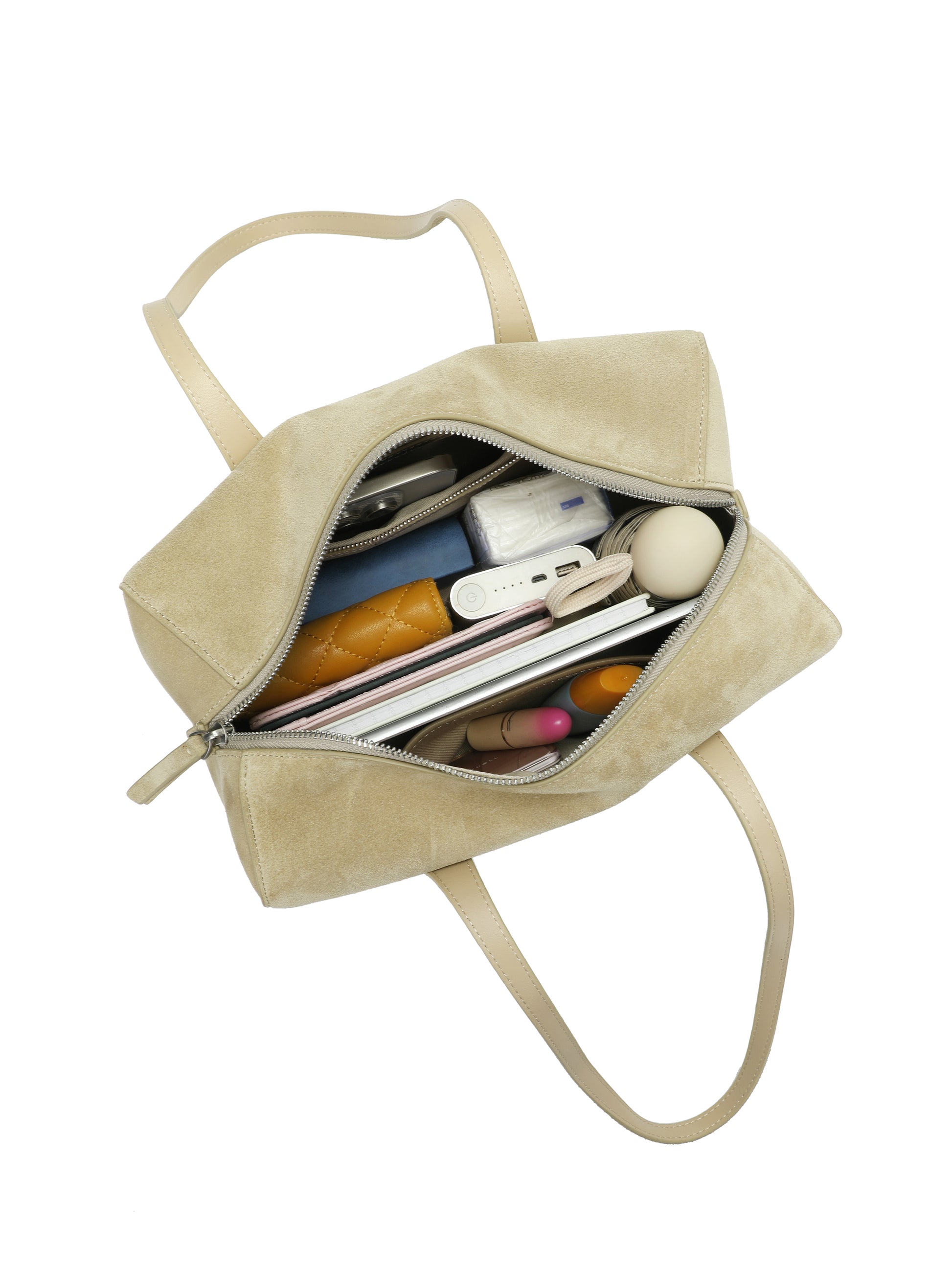 Beige suede tote handbag with zipper, shown open and filled with everyday essentials