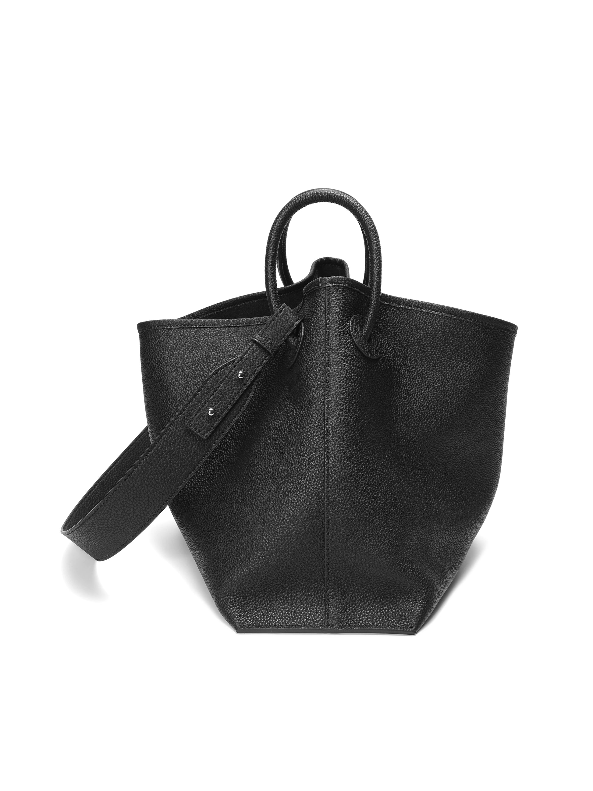 Black leather tote handbag with textured finish and top handles on white background