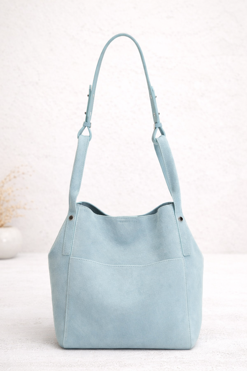 Light blue suede hobo bag with adjustable straps and front pocket