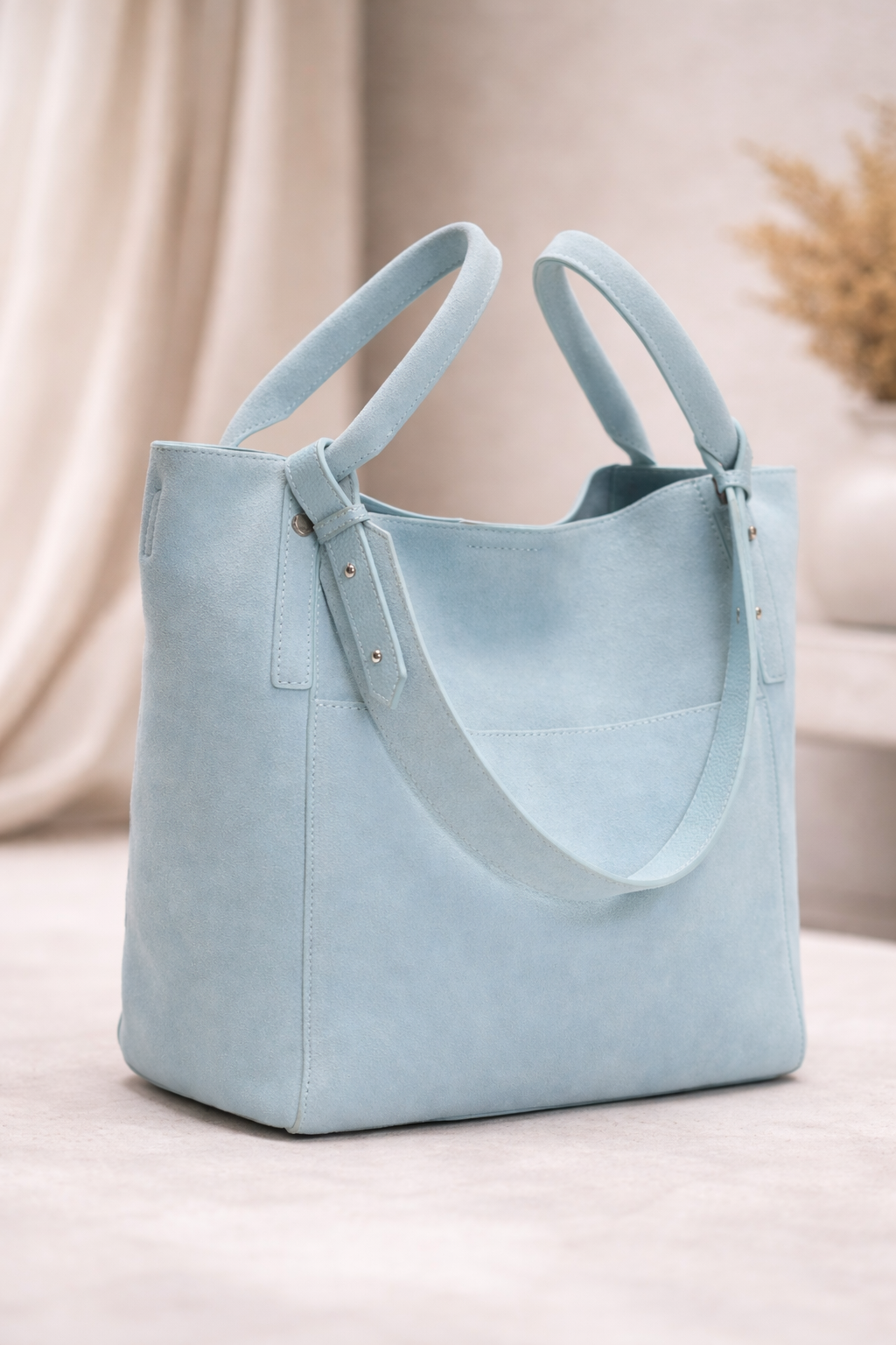 Light blue suede tote bag with dual handles and minimalist design