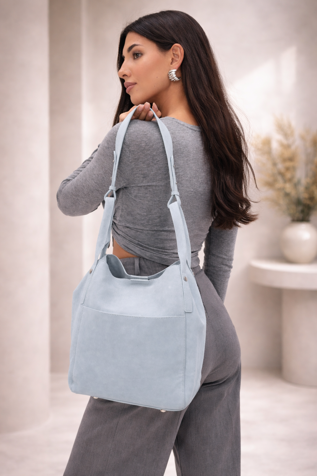 Light blue suede hobo bag with shoulder strap, minimalist design, everyday carryall style