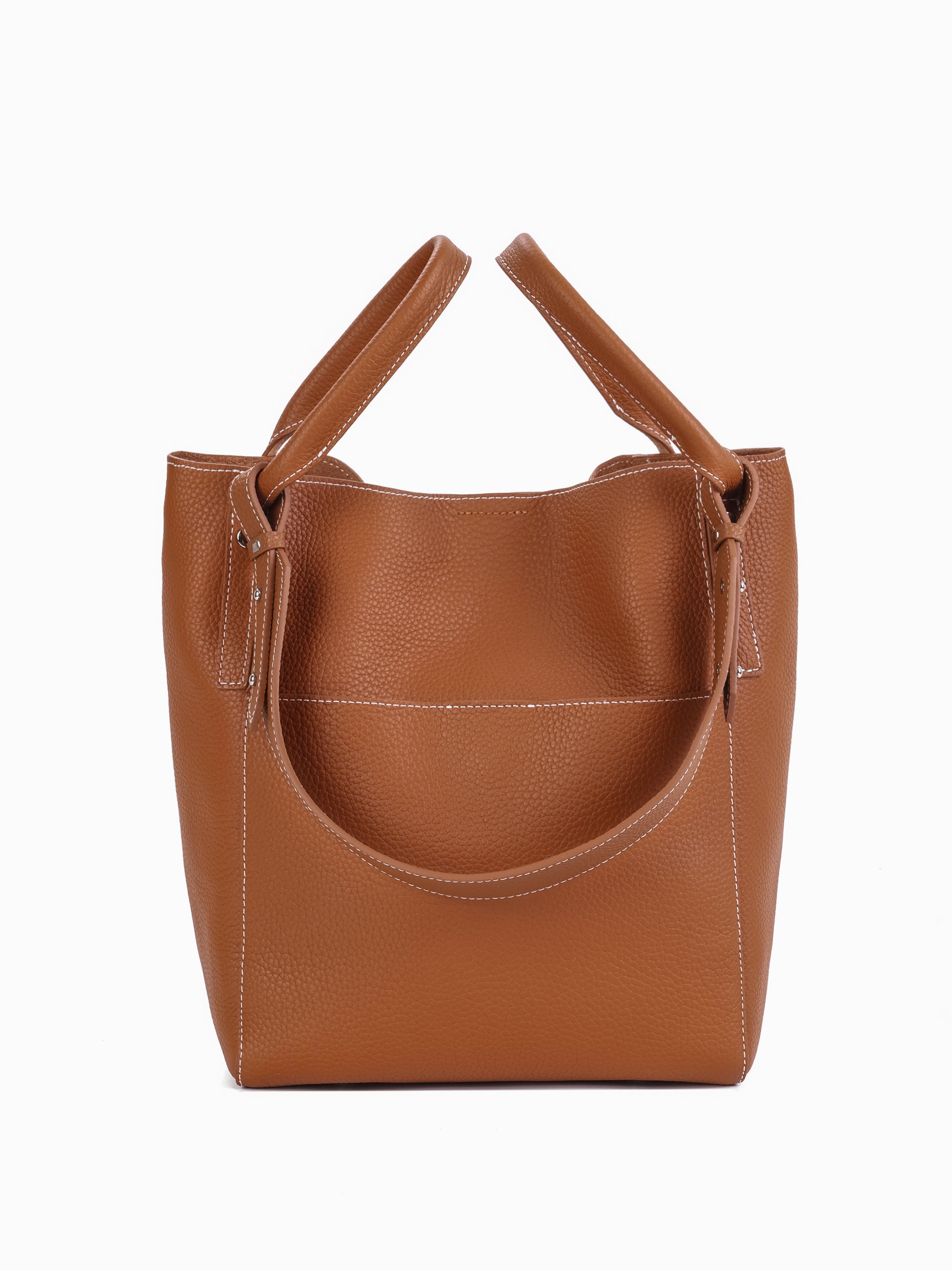 Brown leather tote bag with double handles and visible white stitching on plain background